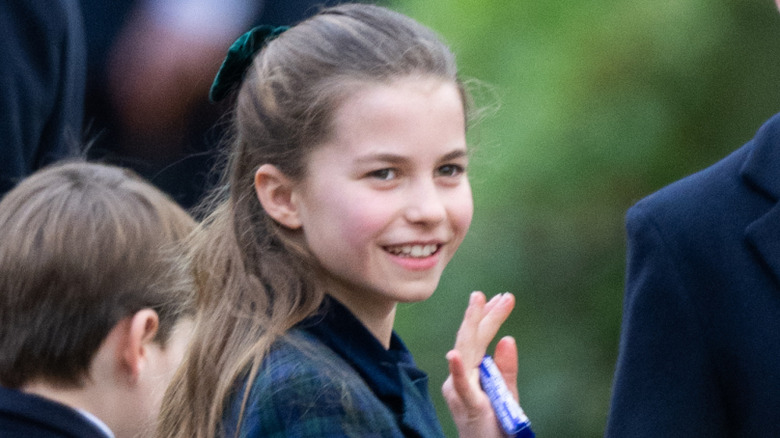 Princess Charlotte waving to the crowd as she walks to Christmas Morning Service, December 25, 2024