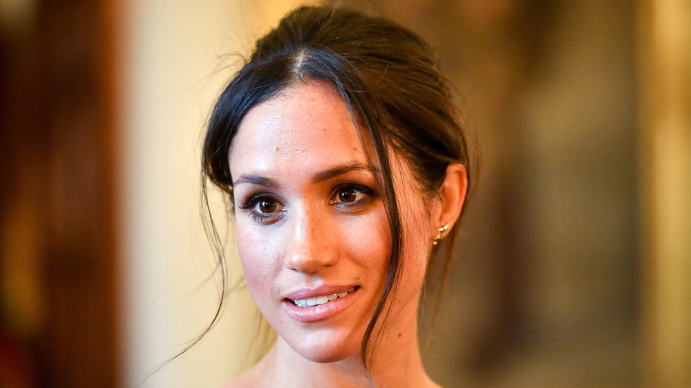 Meghan Markle smiling with hair up