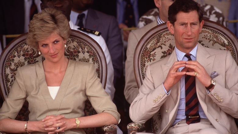 Charles and Diana sit side by side in Cameroon