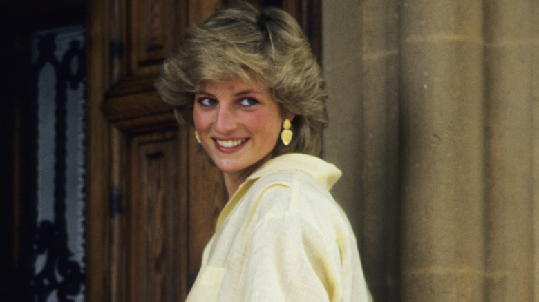 Princess Diana smiling over her shoulder 