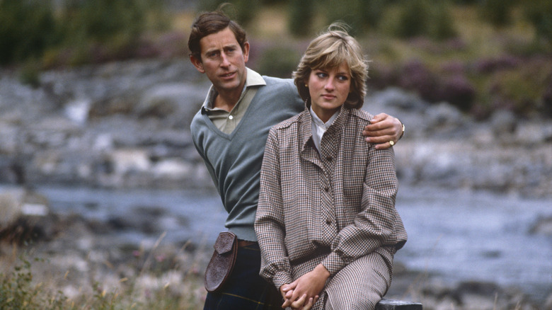 Prince Charles with an arm around Princess Diana