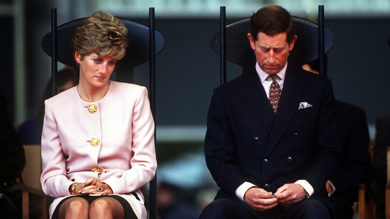 Princess Diana looking sad next to King Charles III