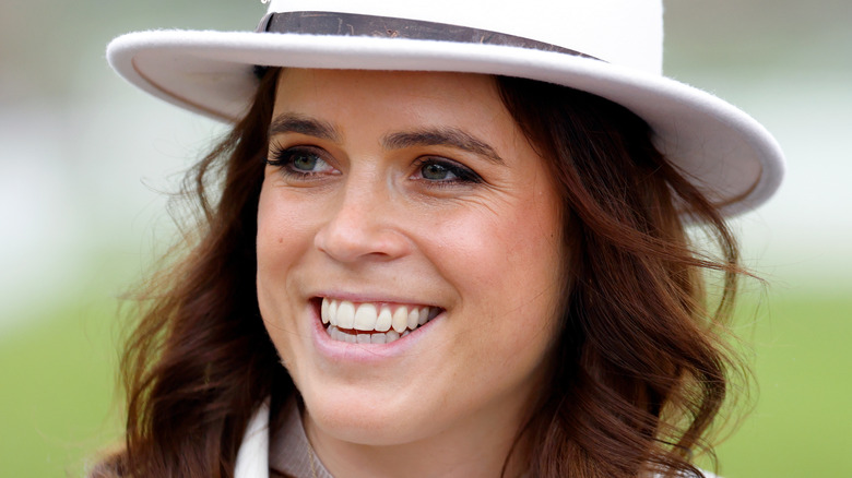 Princess Eugenie smiling in a hat