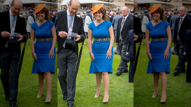 Princess Eugenie walking in blue dress and orange hat