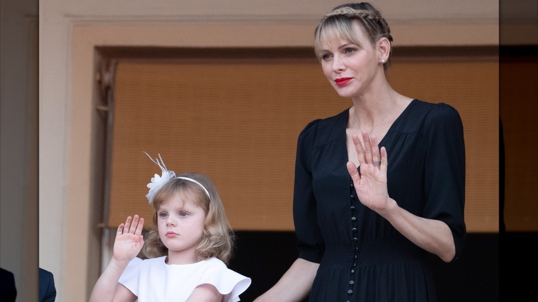 Princess Gabriella and Princess Charlene wave at crowds