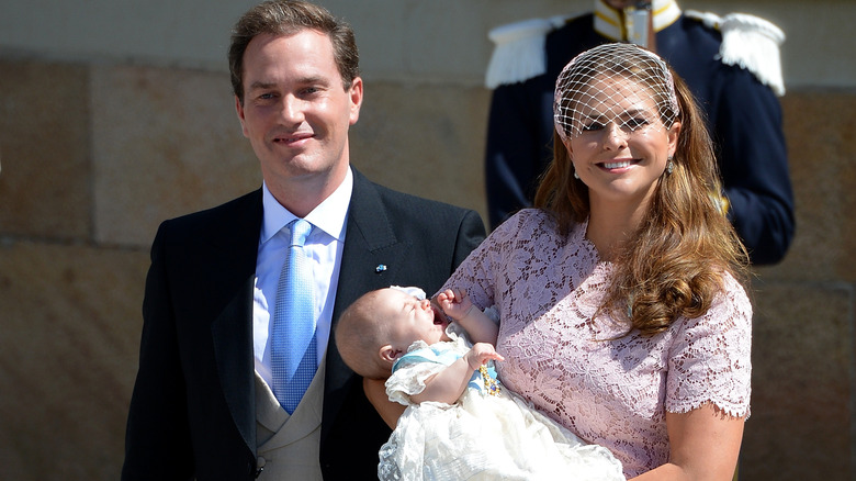 Christopher O'Neill and Princess Madeleine of Sweden carry their daughter Princess after her royal christening at Drottningholm Palace Chapel in Stockholm, Sweden (2014)