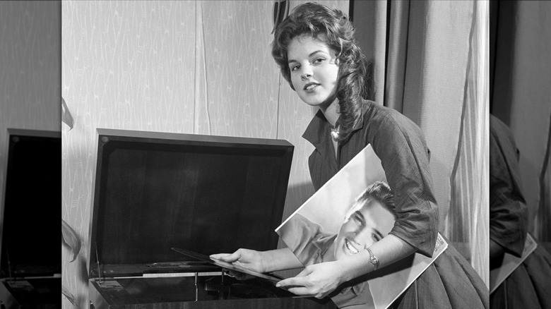 young Priscilla Presley playing Elvis' record