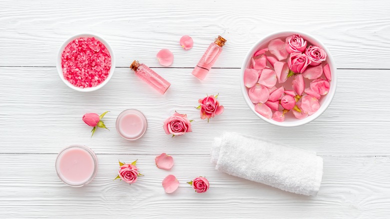 rose water bottles and flowers