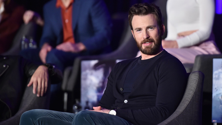 Chris Evans listening onstage during event