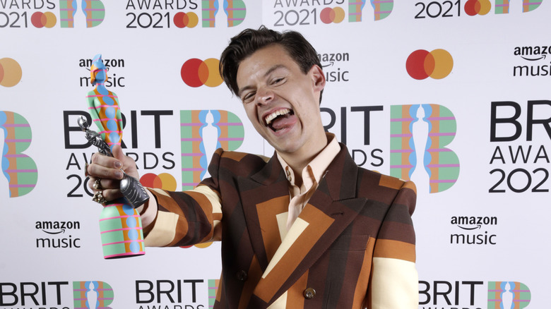 Harry Styles holding Brit award