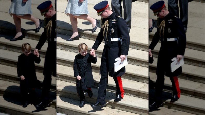 Prince George holding Prince William's hand 