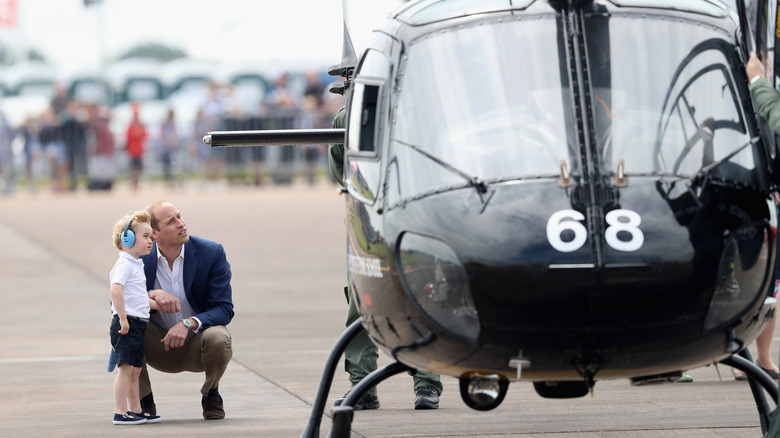 Prince William and Prince George next to helicopter