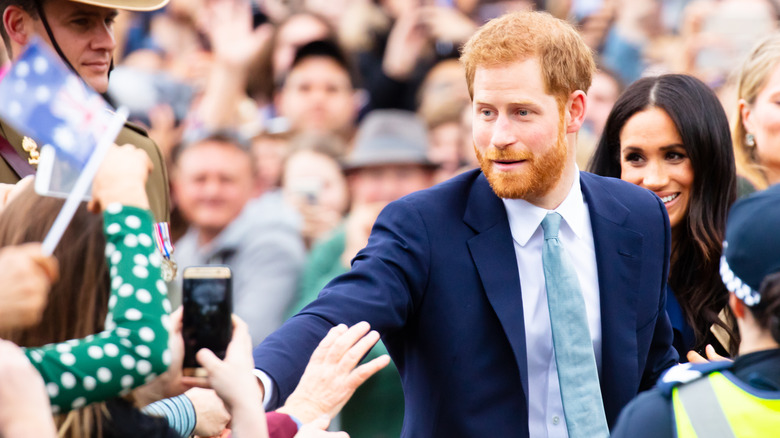 Prince Harry reaches out to fans alongside Meghan Markle