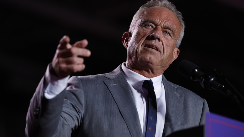 RFK Jr. pointing a finger at a crowd while wearing a suit