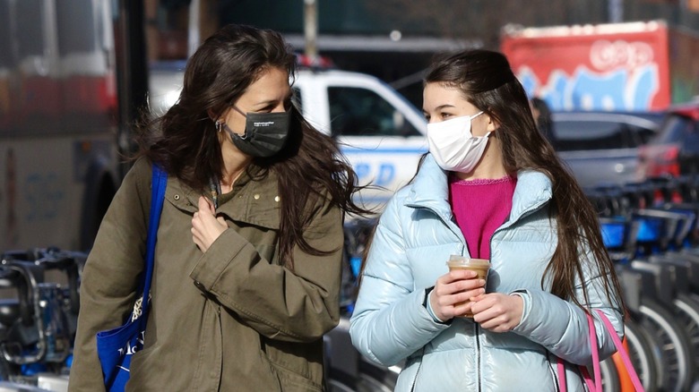 Katie Holmes Suri Cruise walking in masks