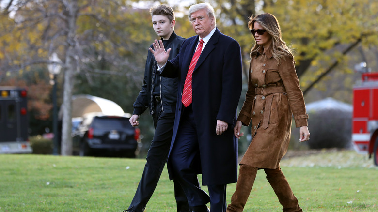 Donald, Barron, and Melania Trump walking on White House lawn