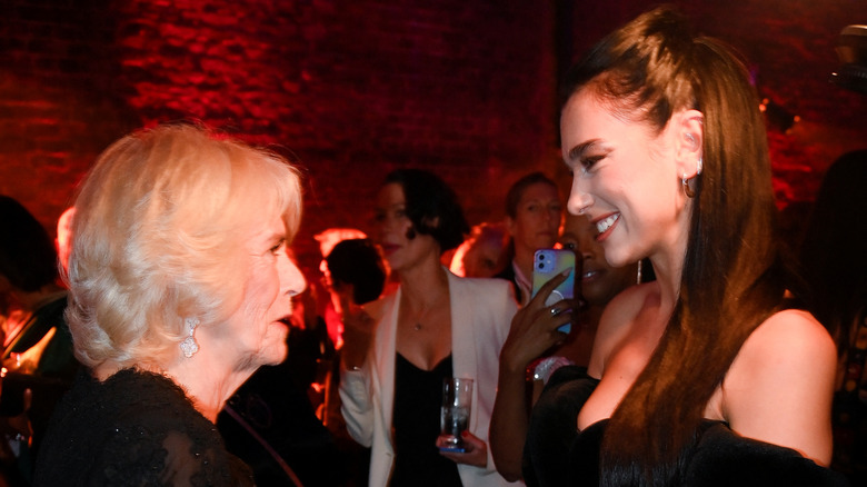 Queen Camilla and Dua Lipa chatting