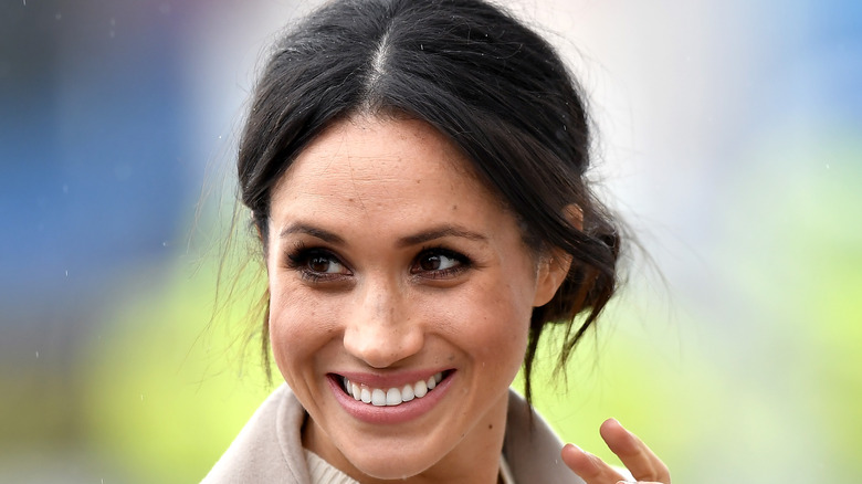 Meghan Markle smiling and waving