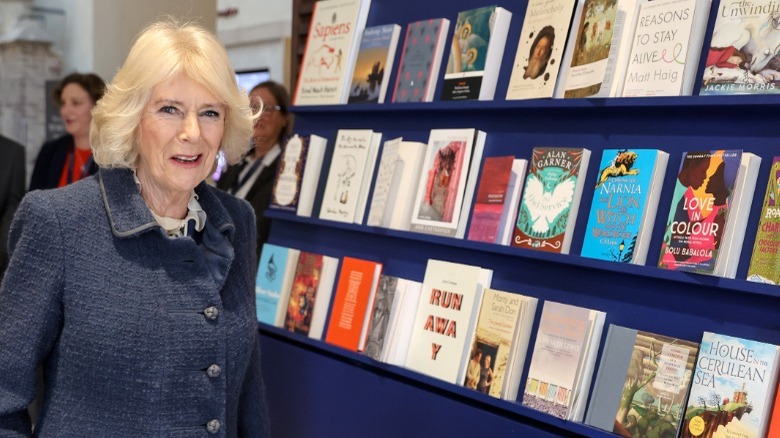 Queen Camilla in front of bookshelves