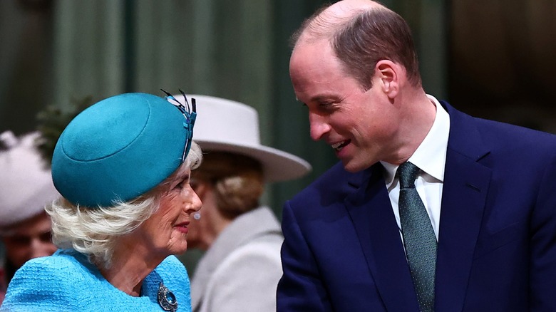 Queen Camilla and Prince William smiling