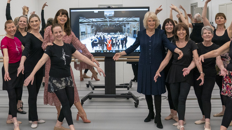 Queen Camilla poses with Silver Swans class members