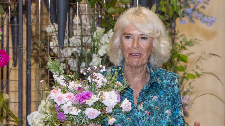 Queen Camilla posing with flowers