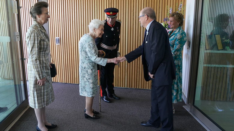 Queen Elizabeth and Princess Anne entering the hospice center