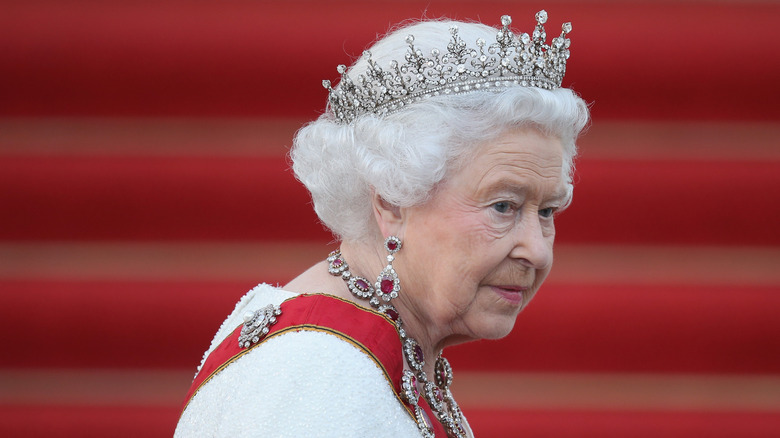 Queen Elizabeth wearing her crown and red jewels