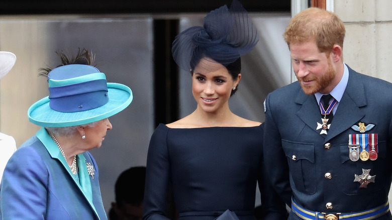 Queen Elizabeth, Meghan Markle, and Prince Harry smiling