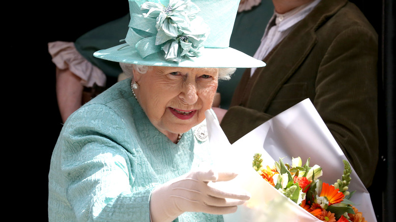 Queen Elizabeth II holding flowers