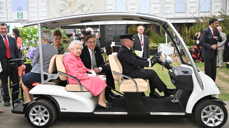 Queen Elizabeth on a golf cart