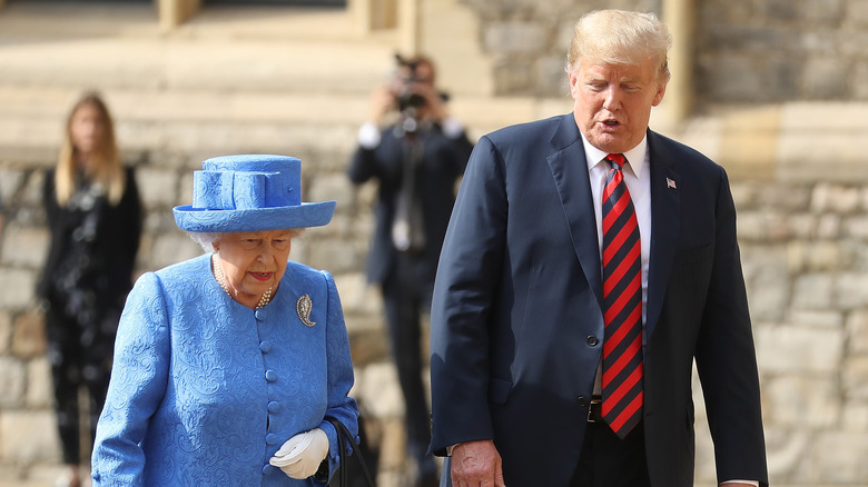 Queen Elizabeth and Donald Trump walking together