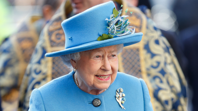 The Queen wearing a light blue hat and coat during a Commonwealth Day Service