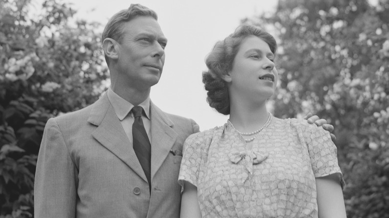 King George VI looking serious and Queen Elizabeth II smiling