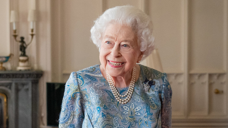 Queen Elizabeth smiling in blue