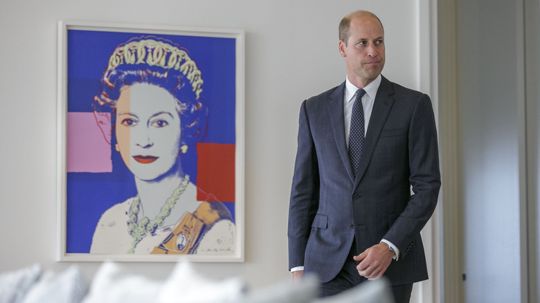 Prince William walking past an Andy Warhol portrait of Queen Elizabeth