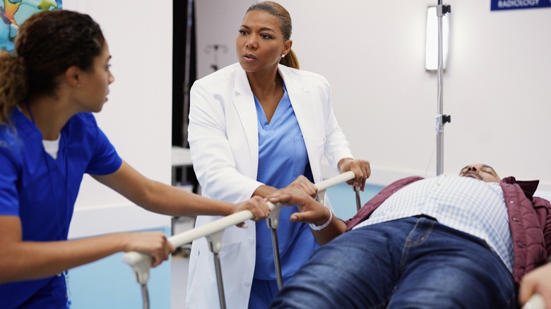 Queen Latifah talking to patient