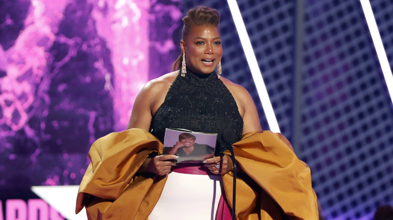 Queen Latifah holds up a picture of her late mother while accepting her BET Lifetime Achievement Award