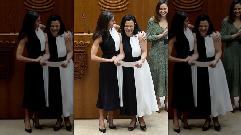 Queen Letizia and woman laughing in matching dresses