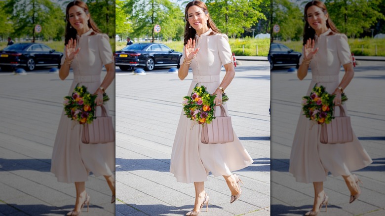 Queen Mary walking and waving