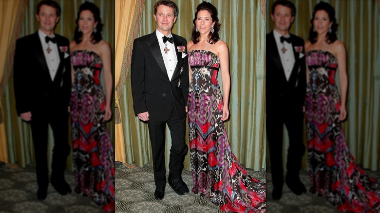 Princess Mary and Prince Frederik of Denmark posing in front of drawn curtains