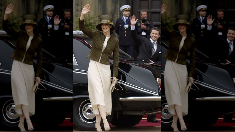 Mary Donaldson and Crown Prince Frederik of Denmark smiling and waving outside their car