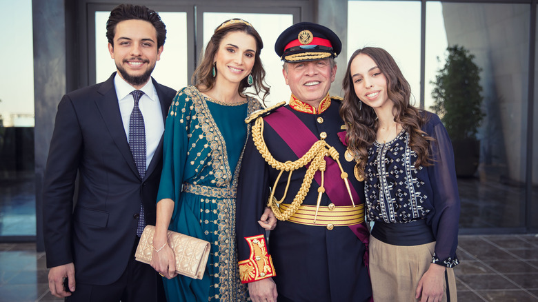 Queen Rania standing with her family