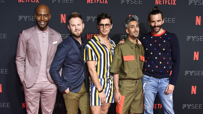 The cast of Queer Eye sitting together on the red carpet
