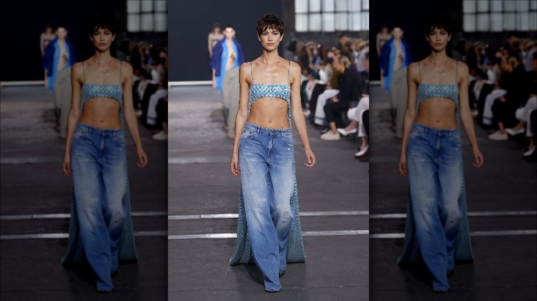 Model wearing low rise jeans, crop top