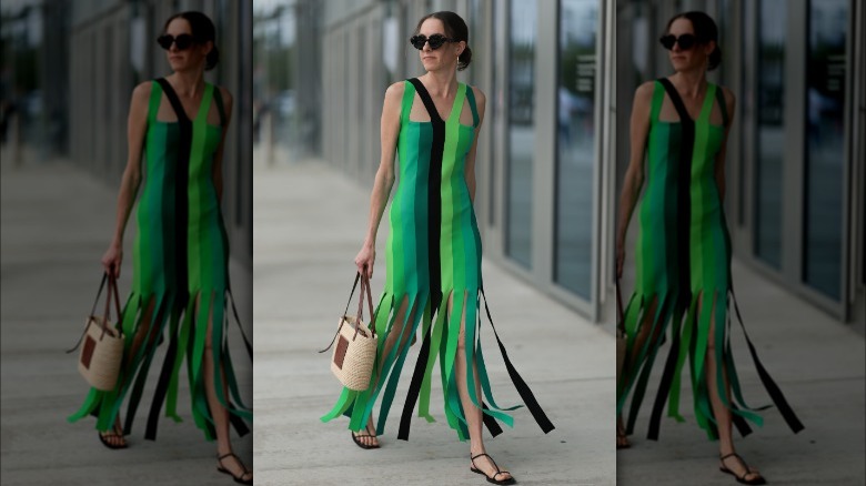 Woman carrying raffia handbag