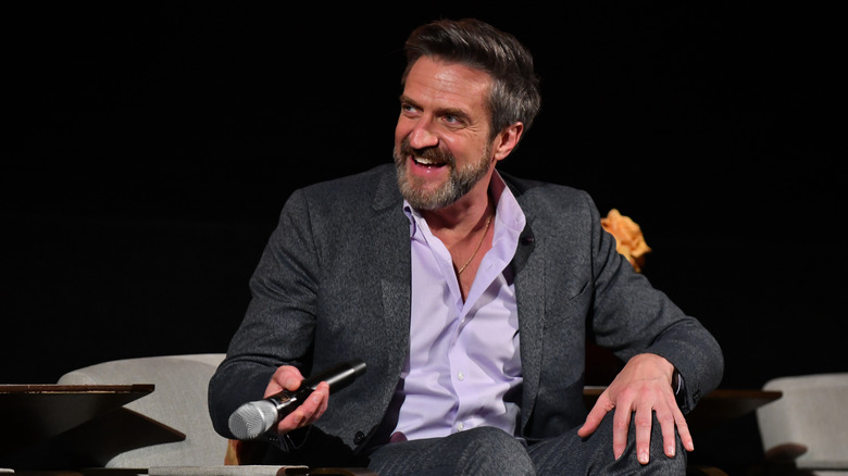 Raul Esparza seated with microphone