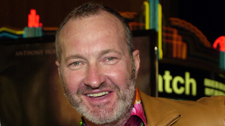 Randy Quaid smiles at an event