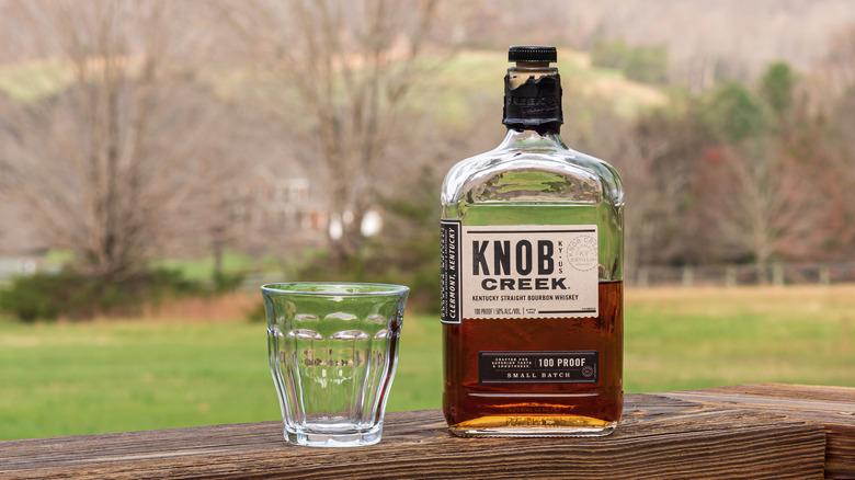 Knob Creek bottle and glass outside