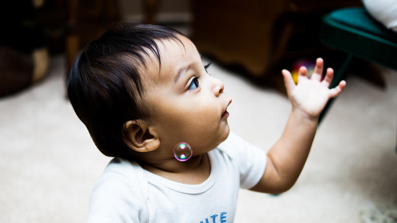 baby blowing bubbles